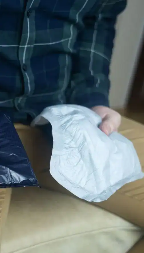 Image of man holding incontinence pads as part of overactive bladder treatment Huddersfield